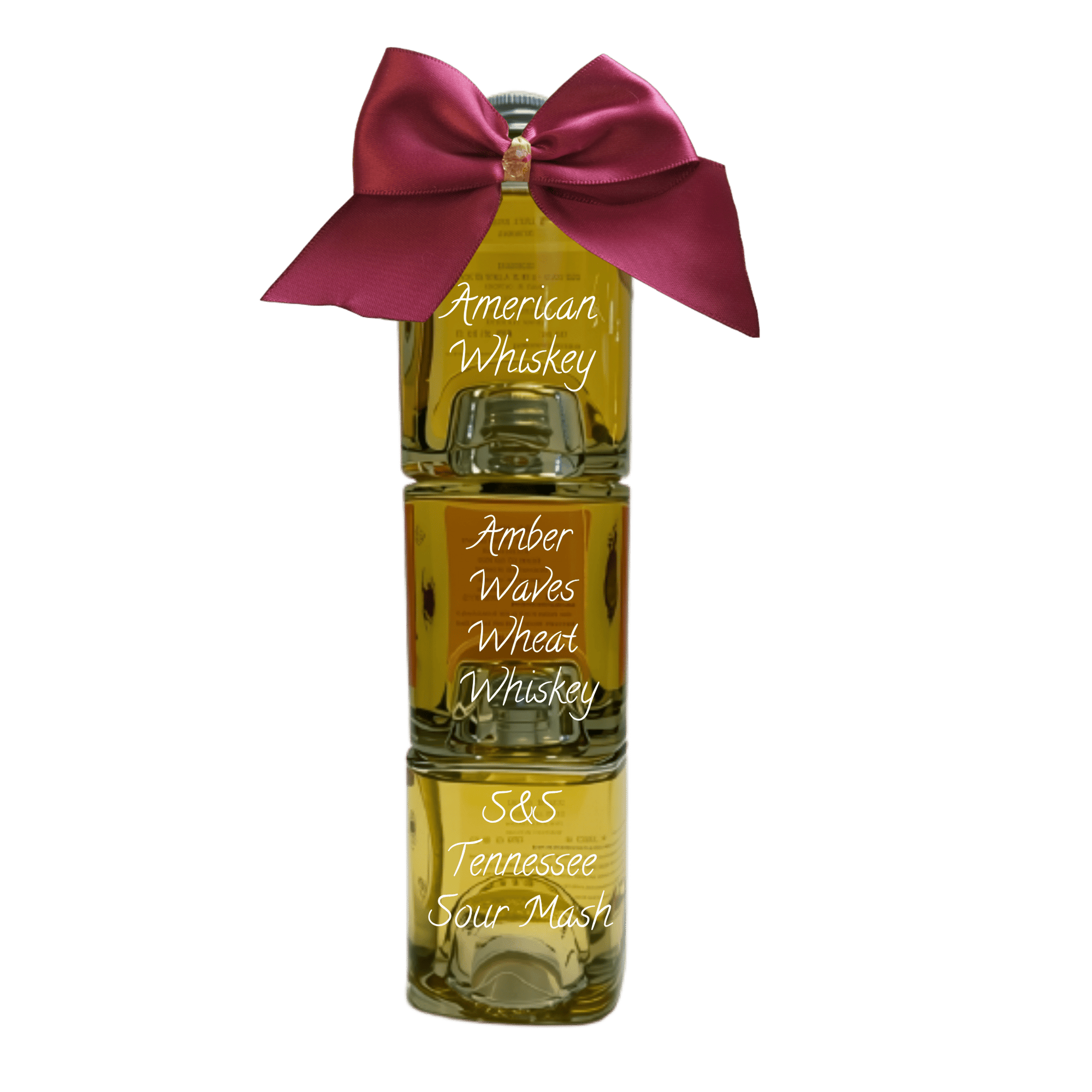 Three stacked glass bottles of whiskey with a large magenta satin bow tied around the neck, labeled 'American Whiskey', 'Amber Waves Wheat Whiskey', and 'S&S Tennessee Sour Mash' on a white background.