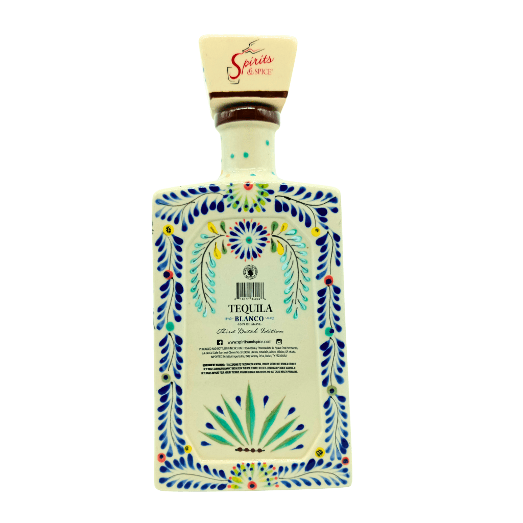Tequila bottle with decorative label on a white background