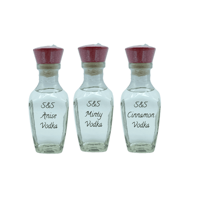Three small bottles of S&S Vodka with red caps on a white background