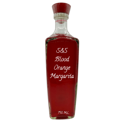 A clear glass bottle filled with a deep red-orange liquid, sealed with a red cap, and labeled 'S&S Blood Orange Margarita' on a plain white background.