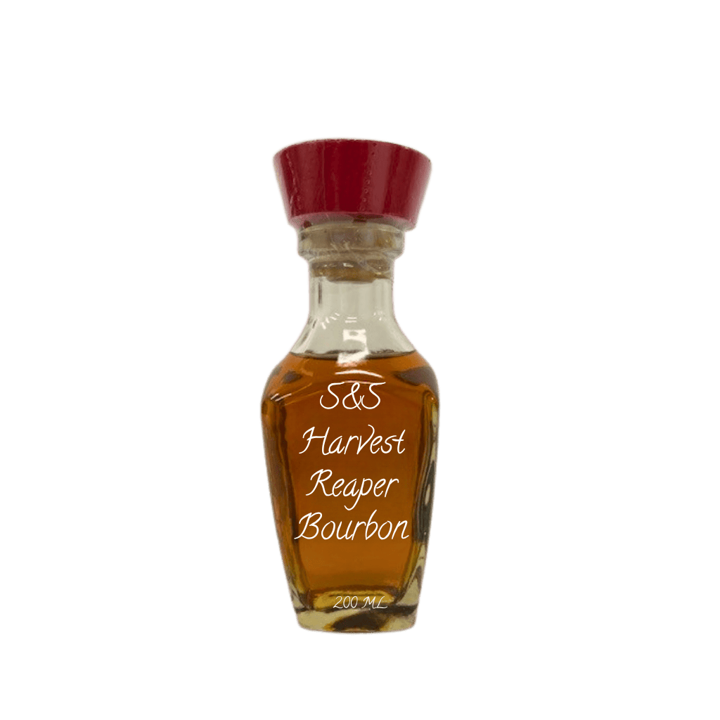 A small clear glass bottle filled with amber-brown bourbon, topped with a dark red cap, on a plain white background. White script on the bottle reads 'S&S Harvest Reaper Bourbon' and '200 ML' appears near the base.
