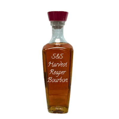 A clear glass bottle of S&S Harvest Reaper Bourbon whiskey with amber-brown liquid, a dark red cap, and white text on the front, isolated on a white background.