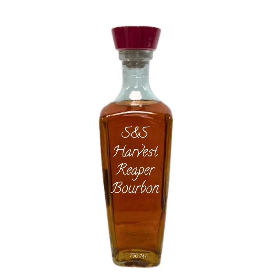 A clear glass bottle of S&S Harvest Reaper Bourbon whiskey with amber-brown liquid, a dark red cap, and white text on the front, isolated on a white background.