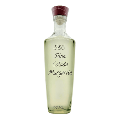 A clear glass bottle of S&S Pina Colada Margarita with a dark red cork stopper, containing a pale yellow liquid, set against a plain white background.