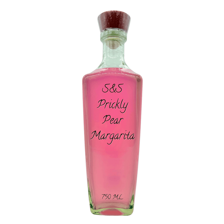 A clear glass bottle filled with pink liquid, featuring a dark brown cork stopper and black handwritten text on the front reading 'S&S Prickly Pear Margaritta' and '750 ML' at the bottom, isolated on a white background.