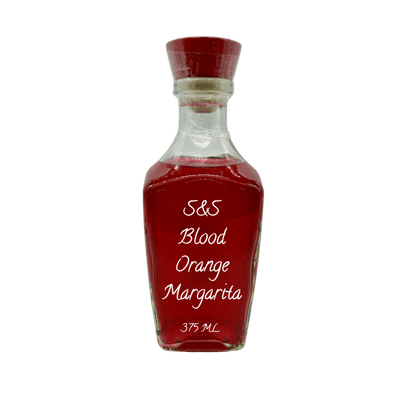 A clear glass bottle filled with a deep red liquid, sealed with a red cap, and labeled 'S&S Blood Orange Margarita 375 ML' in white script, isolated on a white background.