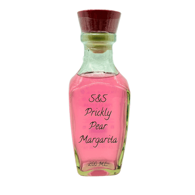 A small glass bottle filled with pink liquid, labeled 'S&S Prickly Pear Margarita 200 ML', topped with a dark red cork stopper, shown on a plain white background.