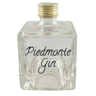 Piedmonte Gin in small bottle. Whiskey alcoholic drinks. Fruity drinks.