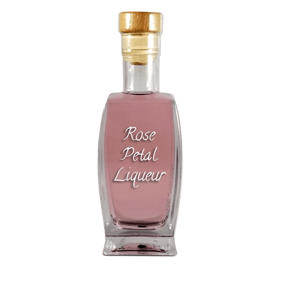 Rose Petal Liqueur in medium bottle. Smooth and sweet alcoholic drinks. Rosé wine.
